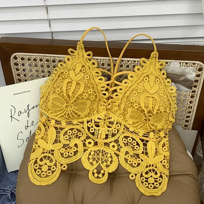 Top displayed hanging on a wooden hanger with palm trees in the background.